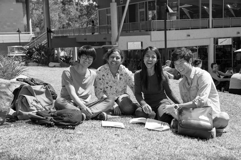 Griffith University - students sitting on grass